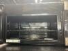Above the range standard stainless steel GE Microwave with rack. 