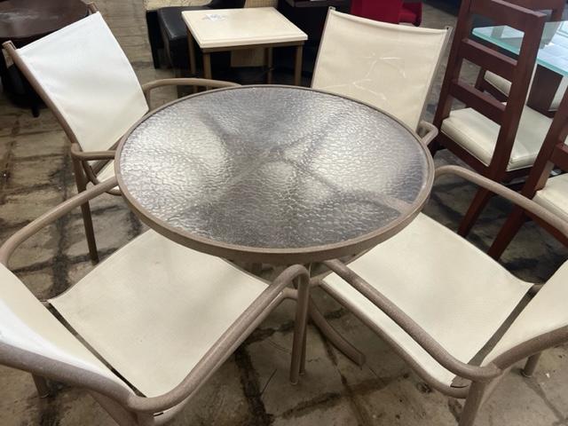 A clear circular table with 4 chairs, perfect for outdoors 