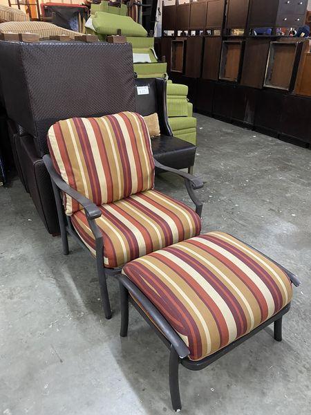 Beautiful aluminum patio chair with a comfortable cushion and ottoman. Warm tone striped 